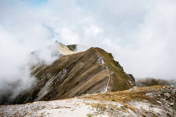 Ridge hiking trail, Alps in Valais, la Brinta, from Vercorin to Grimnetz, Eifischtal, Switzerland Ridge hiking trail, Alps in Valais, la Brinta, from Vercorin to Grimnetz, Eifischtal, Switzerland cairn stock pictures, royalty-free photos & images