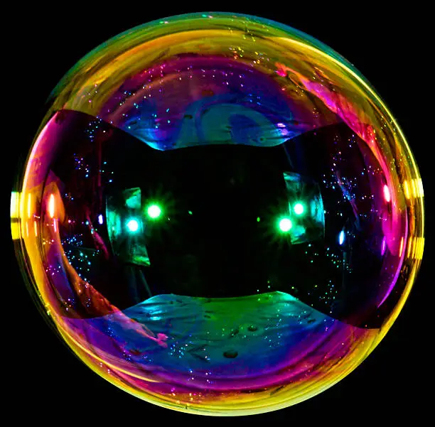 Photo of Big soap bubble on black background