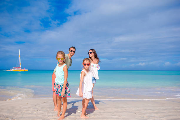 istock Happy family on the beach during summer vacation 1182319092
