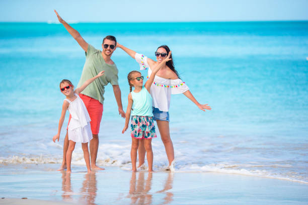 istock Happy family on the beach during summer vacation 1182319786
