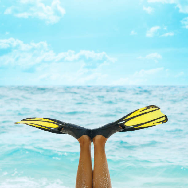 istock Female legs in flippers 1182321750