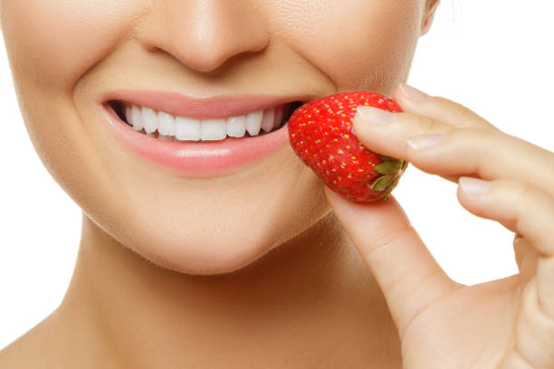 istock Female lips and strawberries 1182325245