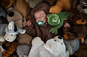 Sleeping baby Hidden in a Pile of Stuffed Animals