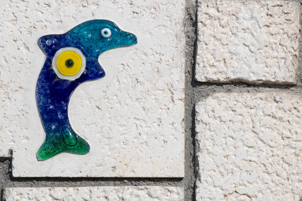 istock Glass dolphin embroidered on the wall and evil eye bead embroidered on it. 1182325466