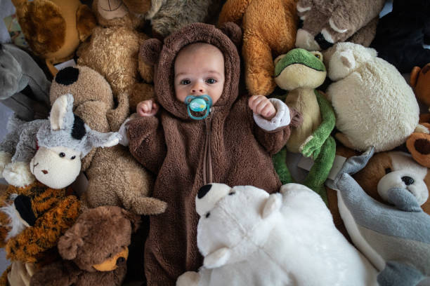 Adorable Baby In Bear Costume Covered By Stuffed Animal Toys Stock Photo -  Download Image Now - iStock