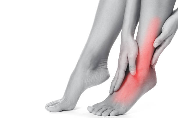 istock Woman is touching her injured ankle 1182329083