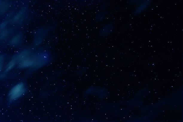 istock Night sky with stars and clouds in motion 1182335789