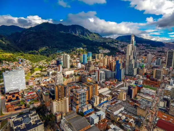 Photo of Bogota cityscape of big buildings and mountains and blue sky