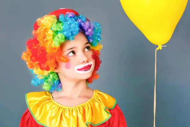 Photo of Portrait of happiness clown girl near yellow air baloon