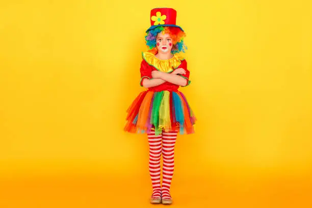 Photo of Full height little clown, crossed hands and have bad mood