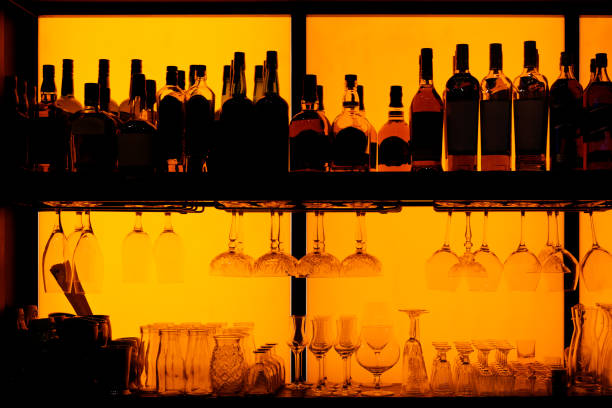 istock Bottles and glasses sitting on shelf in a bar, trade marks removed 1182341908