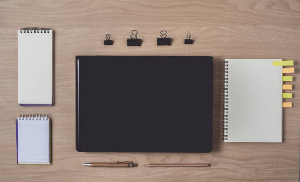 istock Workspace with diary or notebook and clipboard, laptop, pencil, pen, sticky notes on wooden background 1182342972