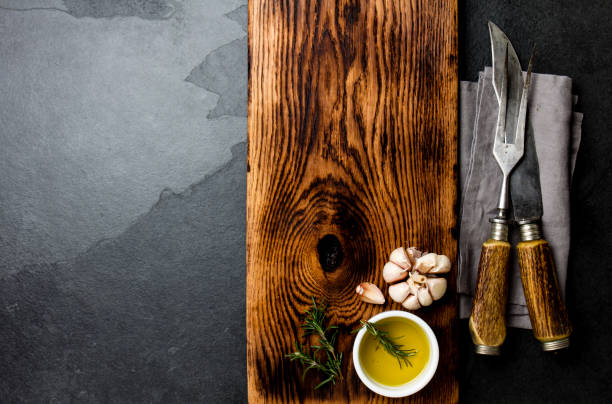 istock Cooking background concept. Vintage cutting board with cutlery. Top view 1182345232