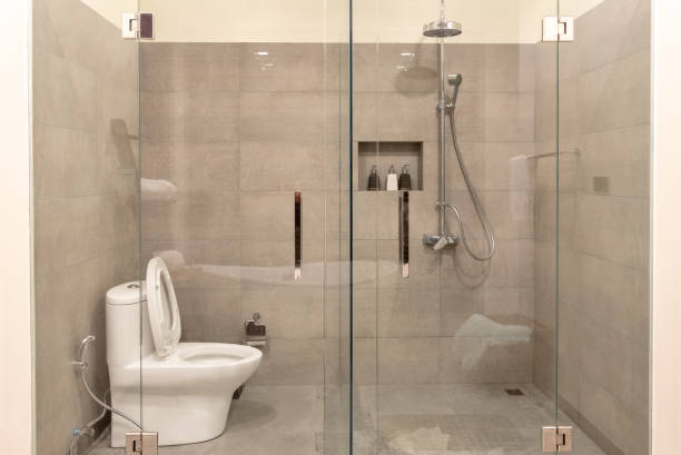 istock Modern bathroom interior with transparent glass partition. 1182352790