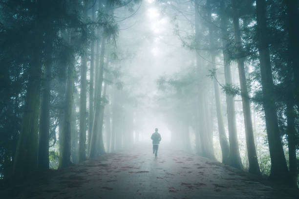 Man running on fog road