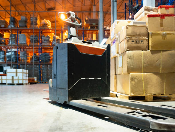 istock Electric forklift pallet jack at warehouse 1182359394