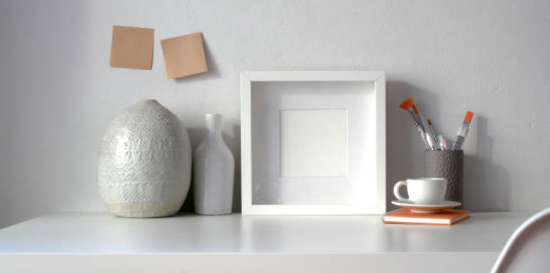 istock Minimal workspace with mock up frame and copy space with ceramic vase decorations 1182361391