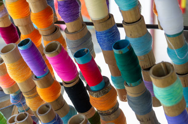 istock Different coloured yarn rolls for umbrella production 1182362259