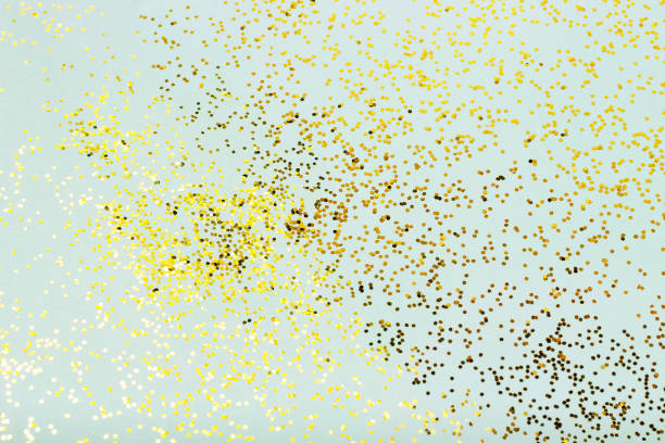 istock Gold sparkles on a blue background close-up, winter texture 1182365220
