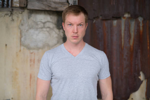 istock Young handsome tourist man against grungy wall 1182369717