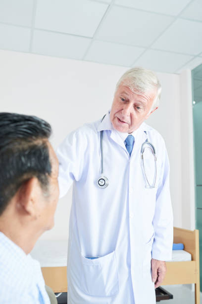 istock Doctor reassuring senior patient 1182369944