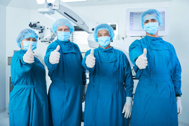 istock Cheerful surgeons showing thumbs-up 1182369971