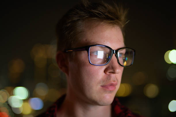 istock Face Of Young Handsome Man With Eyeglasses Thinking At Night 1182370848