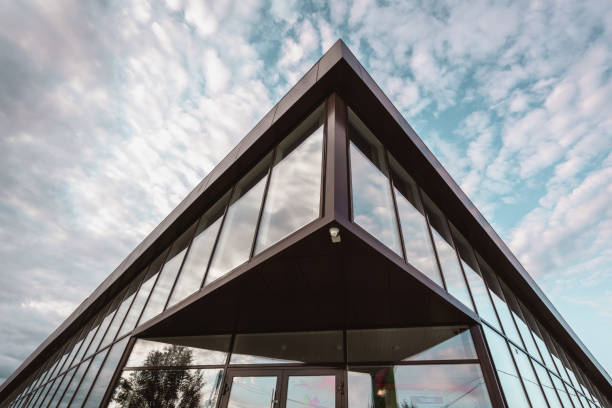 istock Cloudy sky reflecting in windows of a modern building 1182372457