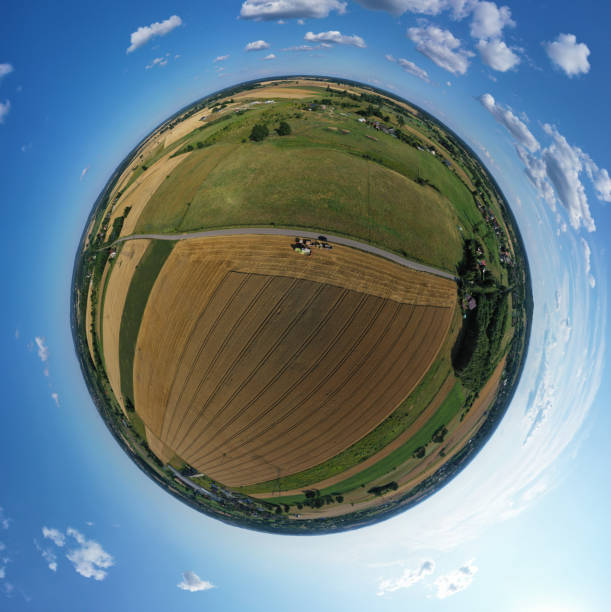 istock Aerial drone 360 degree panoramic view on harvester unloading seed to tractor trailer, agricultural landscape 1182372513