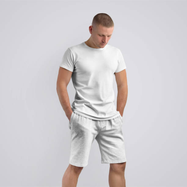 istock Stylish slim model  in a blank T-shirt on a white studio background. 1182376051