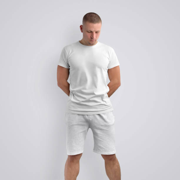 istock Attractive fit guy in a blank T-shirt on a white studio background. 1182376092