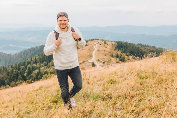 istock man with backpack hiking by autumn mountains copy space 1182377536