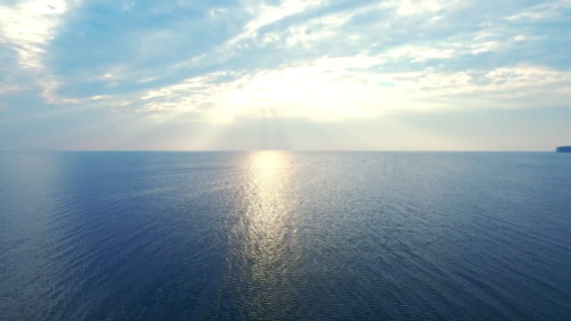 Amazing view sunlight reflecting on sea surface. Drone view blue sea on skyline