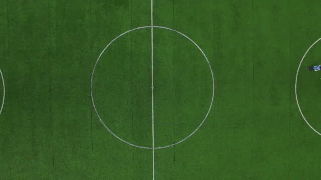 Football marker on field. Drone view soccer players training on football field