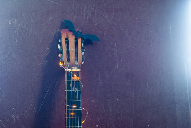 istock Halloween guitar with garland and bat, Halloween background, 1182379417