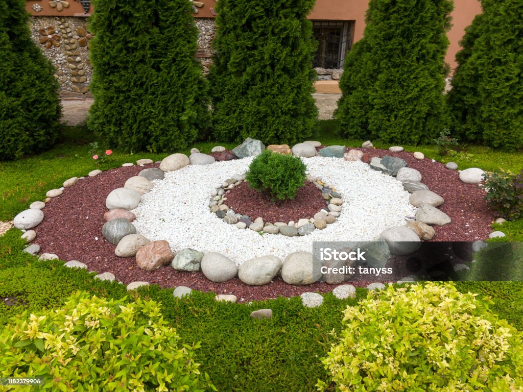 Making flower beds in the park with stones Landscaped Stock Photo