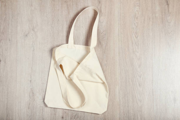 istock White cotton eco bag on wooden background 1182382358
