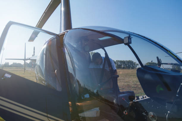 istock Pilot checking passenger cabin in helicopter 1182382827