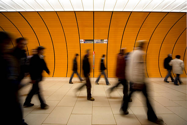 istock motion blurred people against moder orange tunnel 118238338