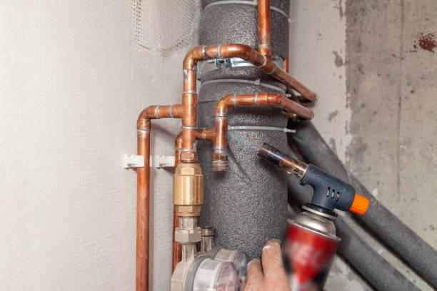 istock Closeup professional plumber soldering copper pipes gas burner, sewage plastic polypropylene gray pipe, insulation. Concept breaking, installation, changing apartment building pipeline, leakage 1182383655