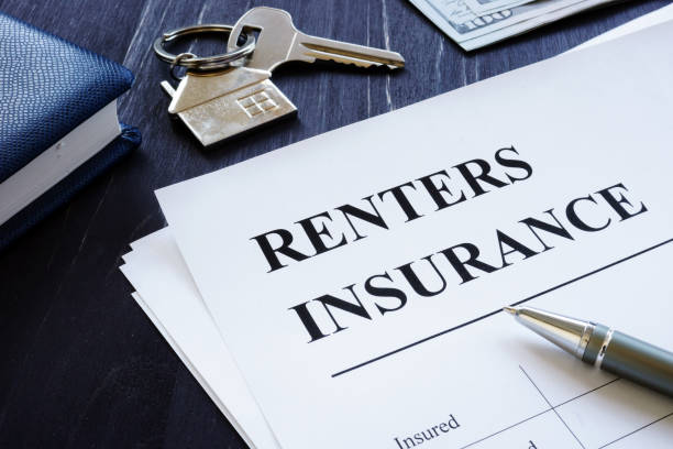 istock Renters Insurance policy agreement and key from apartments. 1182386496