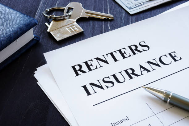 Renters Insurance policy agreement and key from apartments. stock photo