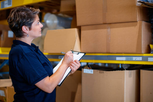 istock Woman checking packages on racks 1182388510