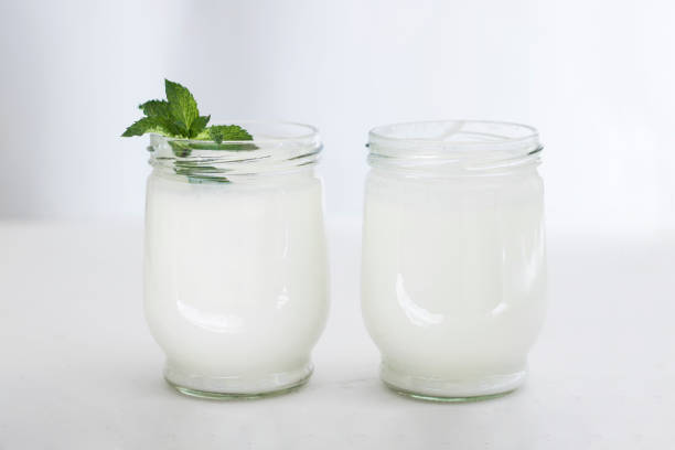 istock Organic probiotic milk kefir drink or yogurt in glass containers,on the white grey background. Gut health. Probiotic cold fermented dairy drink. Trendy food and drink. Copy space 1182388607