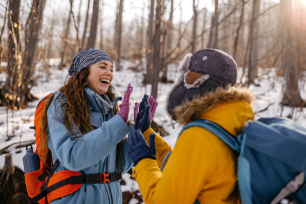 istock Mother and son giving high five in snow 1182389103