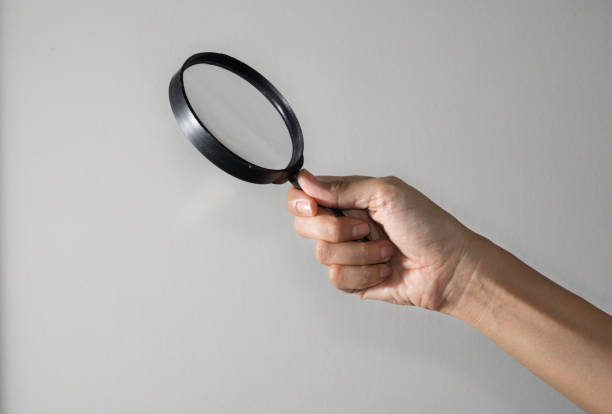 istock Woman hand holding the magnifying glass 1182389919