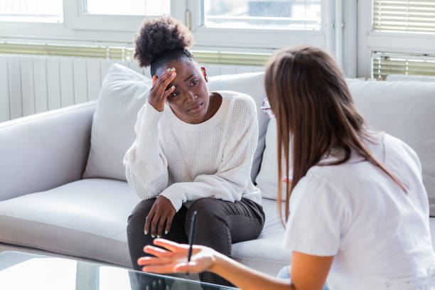 patient receiving bad news, she is desperate and crying, doctor support and comforting her patient with sympathy. don't worry, this medical test is not so bad - patient doctor african descent hospital imagens e fotografias de stock