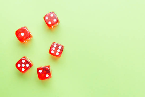 istock Red dice lying on a green background. Place for text 1182390384