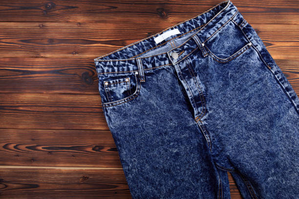 istock blue denim jeans  on wooden background - Image 1182390434