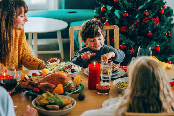 istock Happy mother and her son having fun while eating turkey leg 1182391211